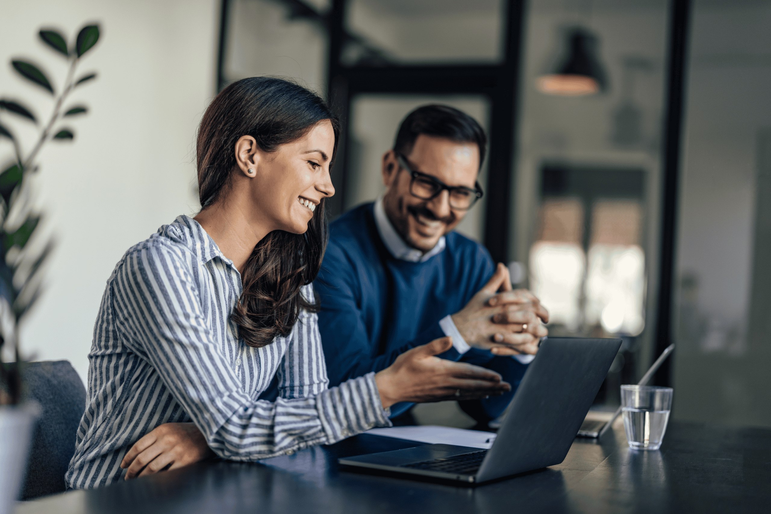 AI Professionals collaborating around a laptop